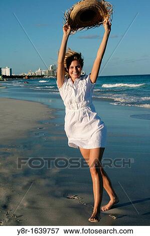 Stock Photo - Woman walking next to seaside. Fotosearch