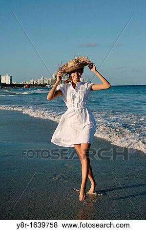 Woman walking next to seaside View Large Photo Image Stock Photo - Woman walking next to seaside. Fotosearch
