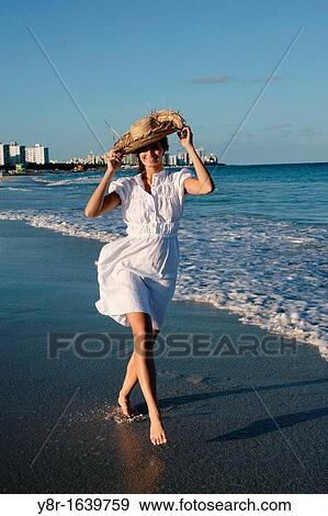 Woman walking next to seaside View Large Photo Image Stock Photo - Woman walking next to seaside. Fotosearch