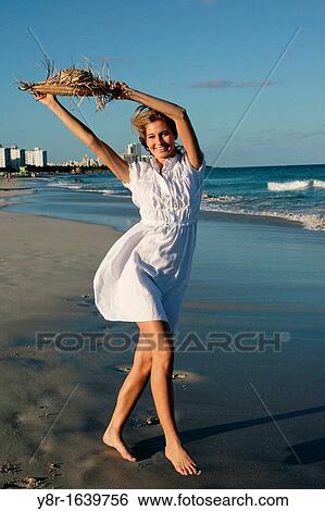 Woman walking next to seaside View Large Photo Image Stock Photograph - Woman walking next to seaside. Fotosearch