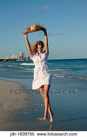 Woman walking next to seaside View Large Photo Image Stock Photography - Woman walking next to seaside. Fotosearch