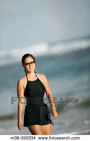Woman walking on a beach in Kauai. USA View Large Photo Image Picture - Woman walking on a beach in Kauai. USA. Fotosearch