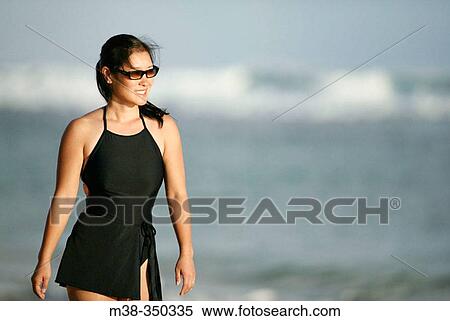 Woman walking on a beach in Kauai. USA View Large Photo Image Stock Photography - Woman walking on a beach in Kauai. USA. Fotosearch
