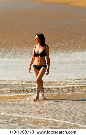 Woman walking on Punta de Tralca beach, Chile. View Large Photo Image Stock Image - Woman walking on Punta de Tralca beach, Chile.. Fotosearch