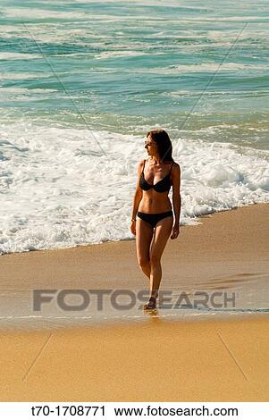 Woman walking on Punta de Tralca beach, Chile. View Large Photo Image Stock Image - Woman walking on Punta de Tralca beach, Chile.. Fotosearch
