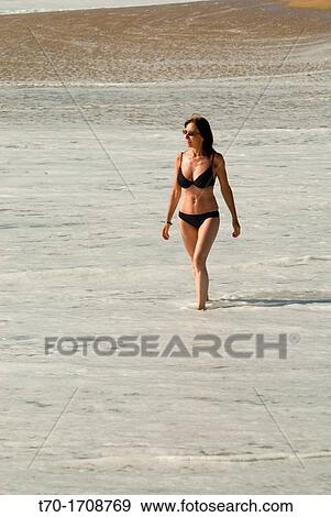 Woman walking on Punta de Tralca beach, Chile. View Large Photo Image Stock Photo - Woman walking on Punta de Tralca beach, Chile.. Fotosearch