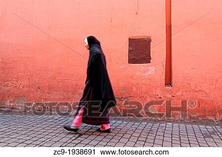 Woman walking on the streets of Marrakech medina, Morocco. View Large Photo Image Stock Image - Woman walking on the streets of Marrakech medina, Morocco.. Fotosearch