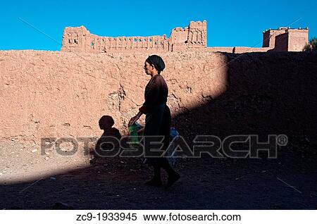 Woman walking on the streets of the mellah (jewish neighborhood), Ouarzazate, Morocco View Large Photo Image Stock Photography - Woman walking on the streets of the mellah (jewish neighborhood), Ouarzazate, Morocco. Fotosearch