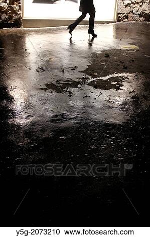 woman walking past shop window in rain at night in city town View Large Photo Image Stock Image - woman walking past shop window in rain at night in city town. Fotosearch