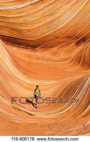 woman walking through a rock formation known as? The Wave?, North Coyote Buttes, Vermillion Cliffs, Paria Wilderness, Utah, USA. View Large Photo Image Stock Photo - woman walking through a rock formation known as? The Wave?, North Coyote Buttes, Vermillion Cliffs, Paria Wilderness, Utah, USA.. Fotosearch