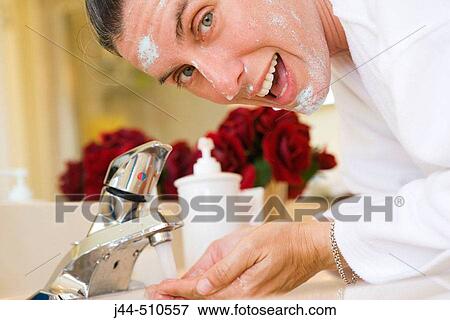 Woman washing face in the bathroom View Large Photo Image Stock Photo - Woman washing face in the bathroom. Fotosearch