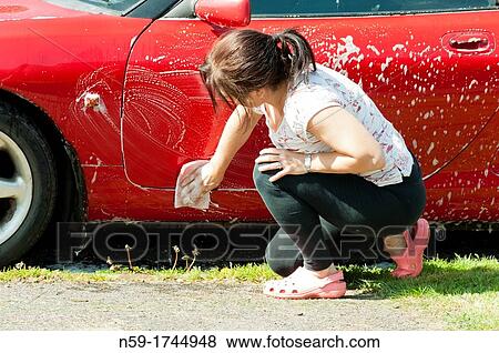 Stock Photo - Woman washing her car. Fotosearch
