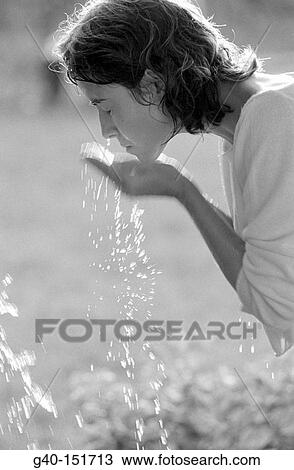 Woman washing her face View Large Photo Image Stock Image - Woman washing her face. Fotosearch