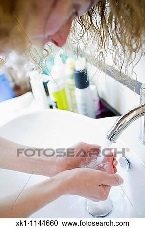 Woman washing her hands View Large Photo Image Stock Image - Woman washing her hands. Fotosearch