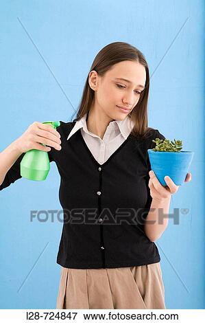 woman watering a plant View Large Photo Image Stock Photo - woman watering a plant. Fotosearch