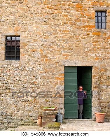 Woman waving from a doorway in Tuscany, Italy View Large Photo Image Stock Photograph - Woman waving from a doorway in Tuscany, Italy. Fotosearch