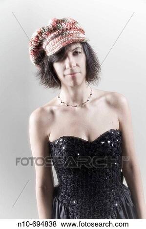 Woman wearing a hat and an evening gown View Large Photo Image Stock Photo - Woman wearing a hat and an evening gown. Fotosearch