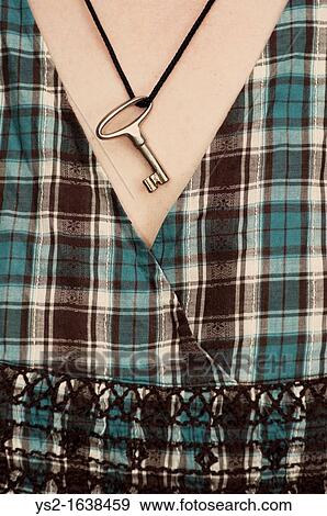 Woman wearing a key around her neck View Large Photo Image Stock Photo - Woman wearing a key around her neck. Fotosearch