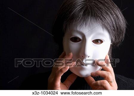 Picture - Woman wearing a plain white mask. Fotosearch