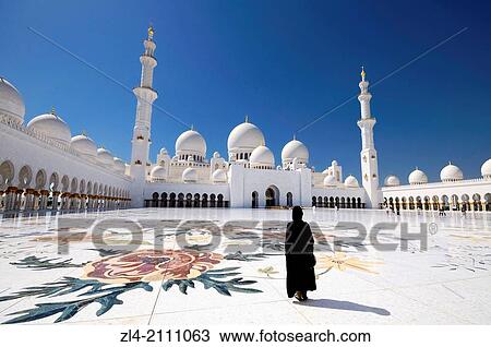 Woman wearing an abaya in the mosque courtyard. United Arab Emirates, UAE, Abu Dhabi, Sheikh Zayed Grand Mosque. View Large Photo Image Stock Image - Woman wearing an abaya in the mosque courtyard. United Arab Emirates, UAE, Abu Dhabi, Sheikh Zayed Grand Mosque.. Fotosearch