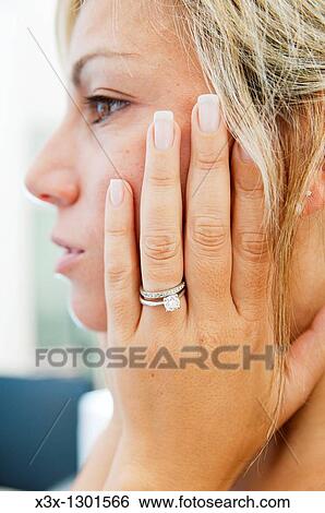 Woman wearing engagement ring View Large Photo Image Stock Photograph - Woman wearing engagement ring. Fotosearch