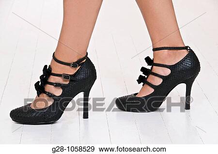 Stock Photo - Woman wearing high heels, leg problems. Fotosearch