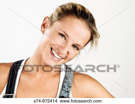 Picture - Woman wearing jean overalls.. Fotosearch
