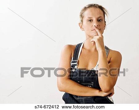 Stock Image - Woman wearing jean overalls.. Fotosearch
