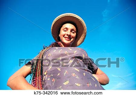 Woman wearing straw hat View Large Photo Image Stock Photograph - Woman wearing straw hat. Fotosearch