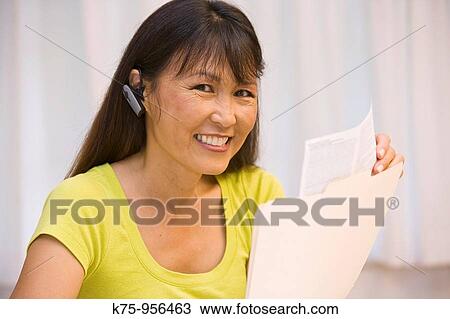 Woman wearing telephone earpiece View Large Photo Image Stock Image - Woman wearing telephone earpiece. Fotosearch