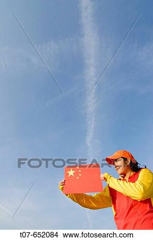 Woman wearing the Chinese Olympic Uniform colors - holding the Chinese flag View Large Photo Image Picture - Woman wearing the Chinese Olympic Uniform colors - holding the Chinese flag. Fotosearch