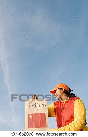 Woman wearing the Chinese Olympic Uniform colors - holding the Chinese flag. View Large Photo Image Stock Photo - Woman wearing the Chinese Olympic Uniform colors - holding the Chinese flag.. Fotosearch