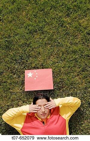 Woman wearing the Chinese Olympic Uniform colors - Chinese flag above head. View Large Photo Image Stock Photo - Woman wearing the Chinese Olympic Uniform colors - Chinese flag above head.. Fotosearch