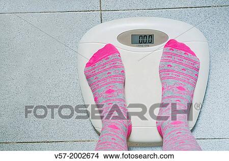 Woman weighing nothing. View Large Photo Image Picture - Woman weighing nothing.. Fotosearch