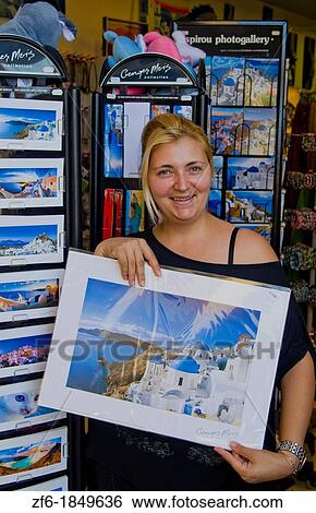 Woman who sells souvenirs in store portrait in Fira in Santorini Greece in Greek Islands View Large Photo Image Stock Photograph - Woman who sells souvenirs in store portrait in Fira in Santorini Greece in Greek Islands. Fotosearch