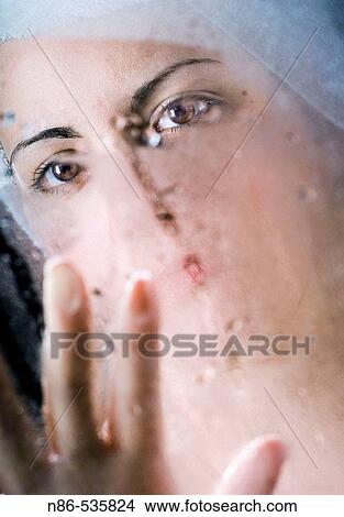 Woman wiping away mirror after shower View Large Photo Image Picture - Woman wiping away mirror after shower. Fotosearch