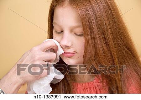 Woman wiping the face of her preteen daughter View Large Photo Image Stock Image - Woman wiping the face of her preteen daughter. Fotosearch