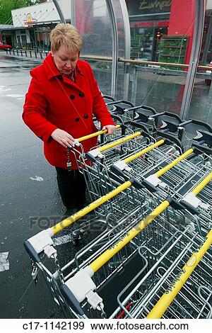woman with a cart during shopping in a supermarket, D-Oberhausen, Ruhr area, Lower Rhine, North Rhine-Westphalia, D-Oberhausen-Sterkrade View Large Photo Image Stock Photo - woman with a cart during shopping in a supermarket, D-Oberhausen, Ruhr area, Lower Rhine, North Rhine-Westphalia, D-Oberhausen-Sterkrade. Fotosearch