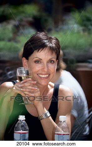 Woman with a glass of water View Large Photo Image Picture - Woman with a glass of water. Fotosearch