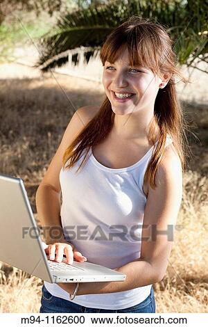 Woman with a laptop in her hands View Large Photo Image Stock Image - Woman with a laptop in her hands. Fotosearch
