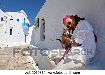 Woman with a local cat, Amorgos, Cyclades Islands, Greek Islands, Greece, Europe. View Large Photo Image Stock Photo - Woman with a local cat, Amorgos, Cyclades Islands, Greek Islands, Greece, Europe.. Fotosearch