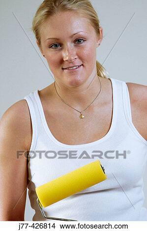 Woman with a paint roller. View Large Photo Image Picture - Woman with a paint roller.. Fotosearch