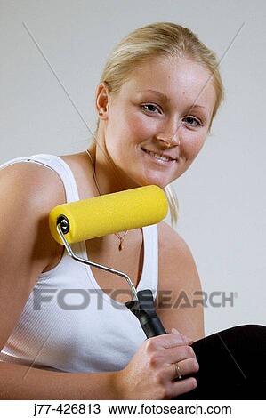 Woman with a paint roller. View Large Photo Image Stock Image - Woman with a paint roller.. Fotosearch