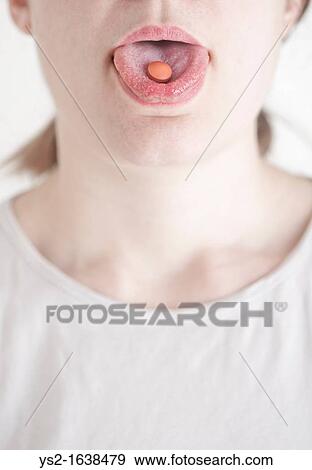 Woman with a pill on her tongue View Large Photo Image Stock Photo - Woman with a pill on her tongue. Fotosearch