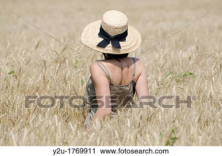 Woman with a straw hat standing up in the wheat field View Large Photo Image Stock Image - Woman with a straw hat standing up in the wheat field. Fotosearch