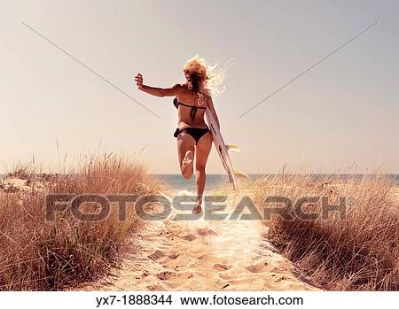 Woman with a surf board running to the beach. Tarifa, Costa de la Luz, Cadiz, Andalusia, Spain, Europe. View Large Photo Image Picture - Woman with a surf board running to the beach. Tarifa, Costa de la Luz, Cadiz, Andalusia, Spain, Europe.. Fotosearch