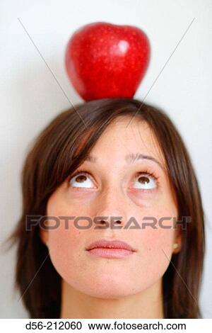 Woman with apple on her head View Large Photo Image Stock Image - Woman with apple on her head. Fotosearch