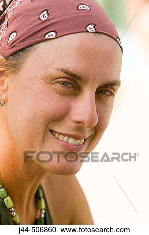Stock Image - Woman with bandanna in head smiling. Fotosearch