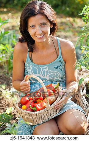 Woman with basket filled with freshly harvested vegetables. View Large Photo Image Stock Image - Woman with basket filled with freshly harvested vegetables.. Fotosearch