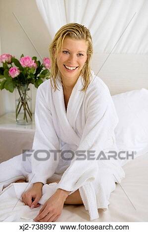 Stock Photo - Woman with bathrobe at home. Fotosearch